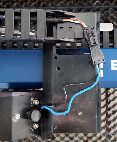 Closer view of screws and cable clamps to remove