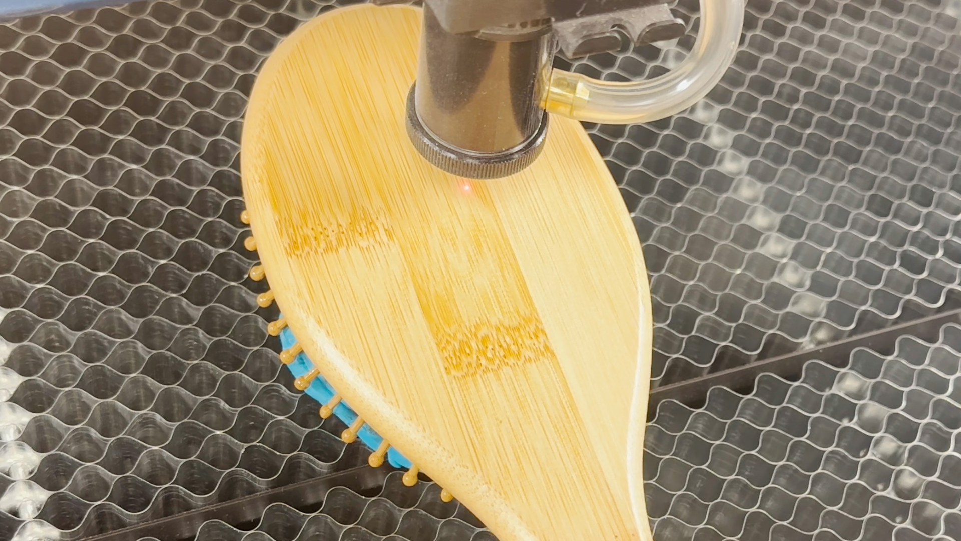 Laser head positioned on material with control panel