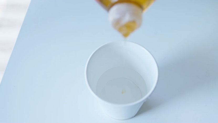 Adding dish soap to distilled water.