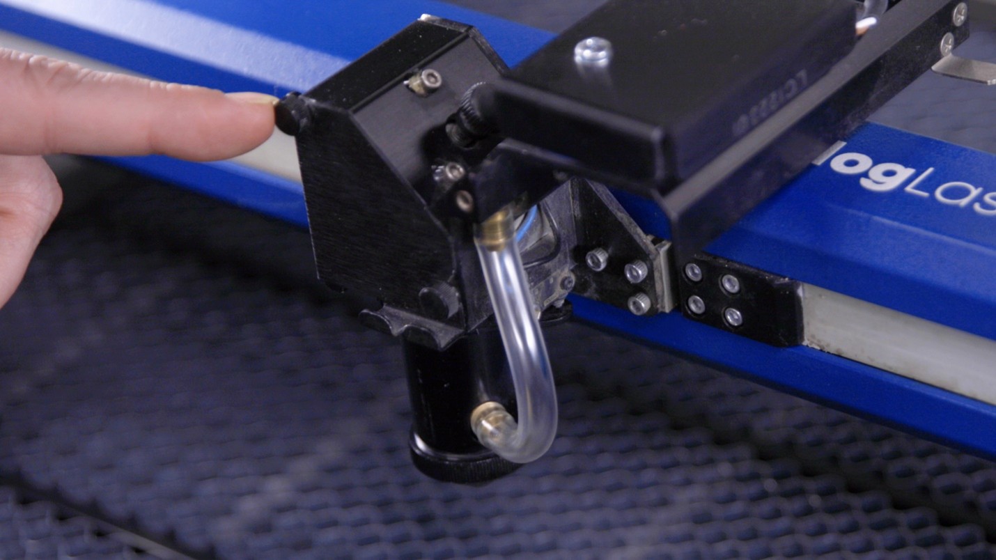 A finger touching a machine