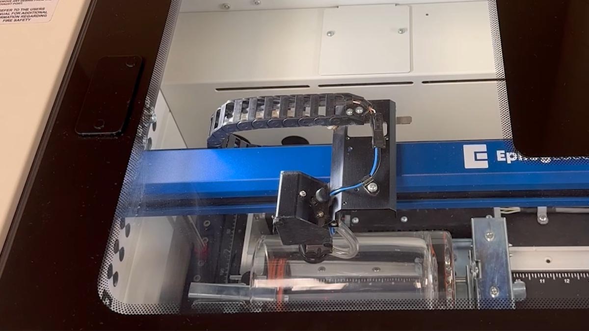 At the laser, jog the laser head to your ideal center point. selecting the centering point at the laser with the Rim-Style rotary attachment