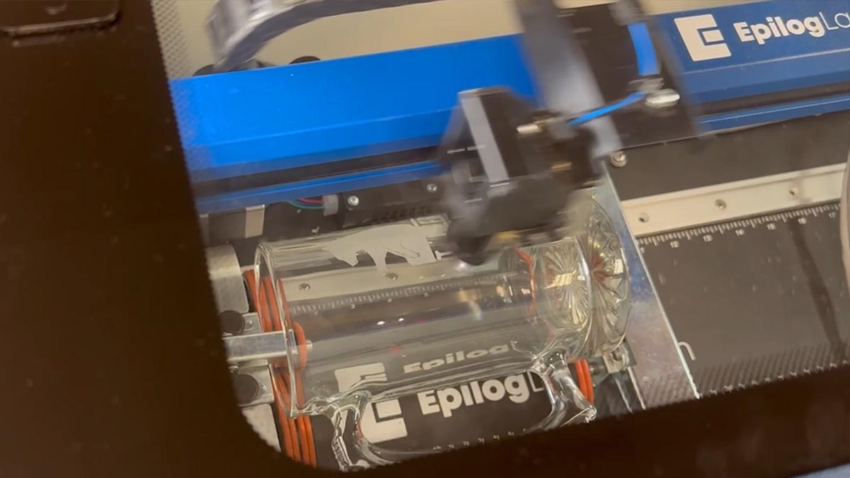 Run the job at the laser. laser engraving glass mug on a Rim-Style rotary attachment